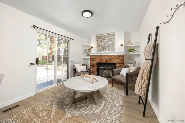 a living room with furniture a fireplace and a table
