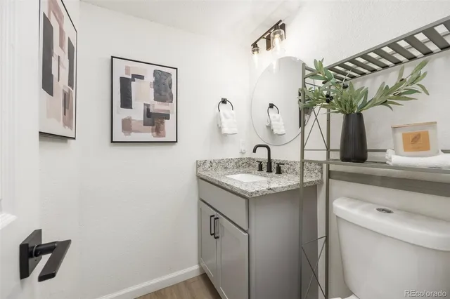 a bathroom with a granite countertop sink a mirror and shower
