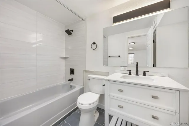 a view of a white house with a yard and large tree and plants