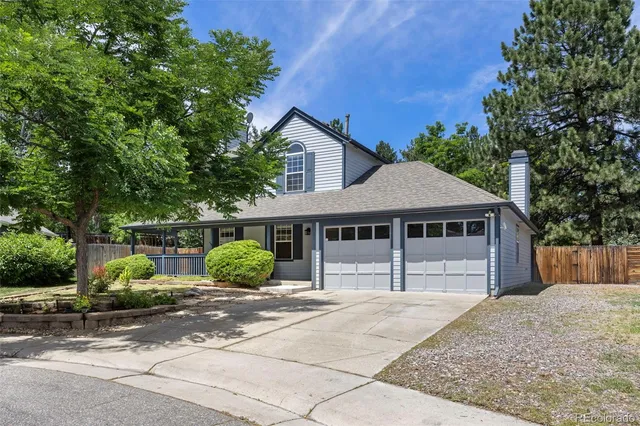 a house that has a tree in front of it