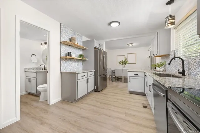 a kitchen with a sink cabinets and wooden floor