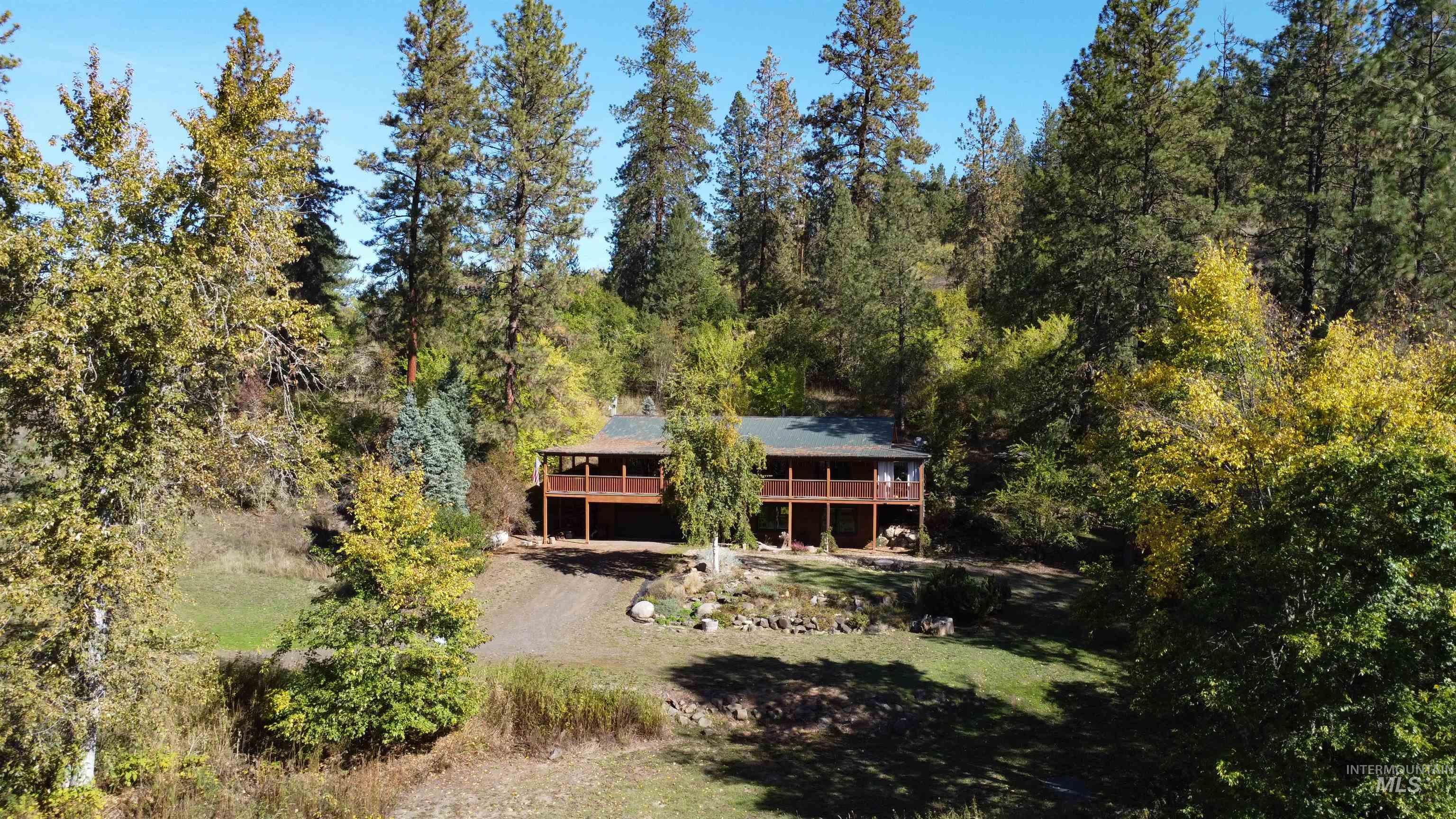 4480 Highway 12 Kamiah, ID 83536 - Photo 22 of 49 Aerial view of property and surrounding area with a heavily wooded area