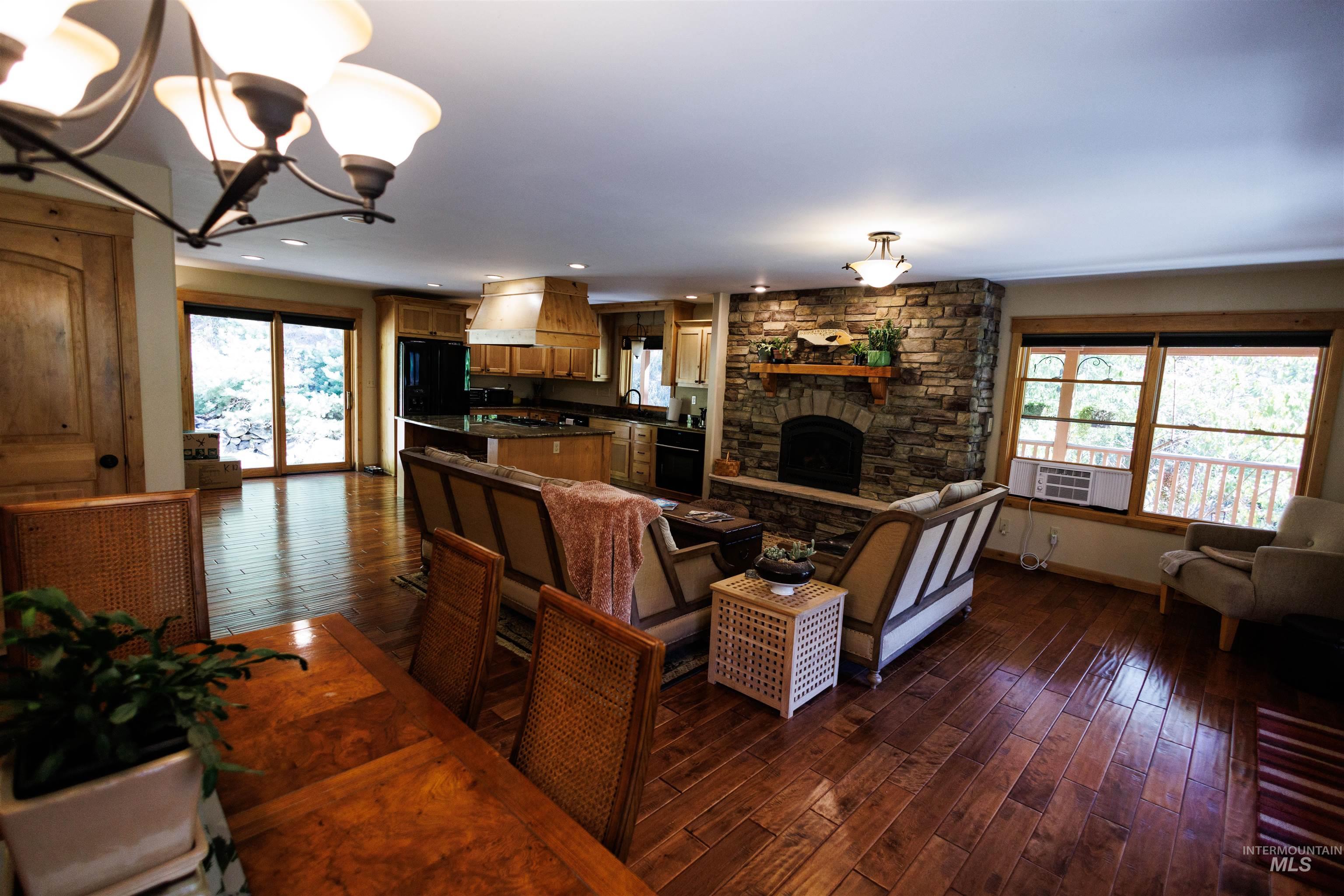 4480 Highway 12 Kamiah, ID 83536 - Photo 26 of 49 Living room featuring a chandelier, dark wood-type flooring, and a fireplace