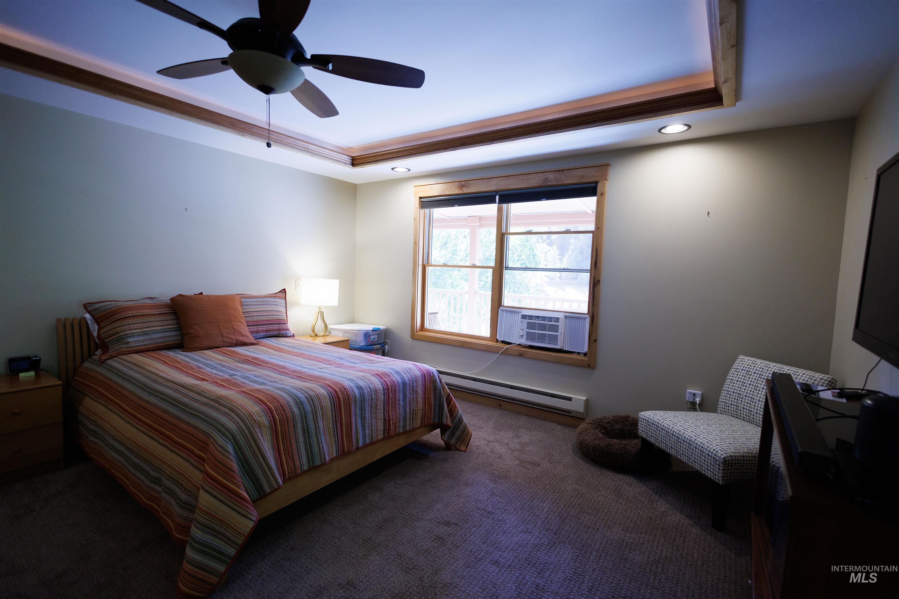 4480 Highway 12 Kamiah, ID 83536 - Photo 32 of 49 Bedroom featuring a raised ceiling, carpet flooring, a baseboard radiator, ceiling fan, and recessed lighting