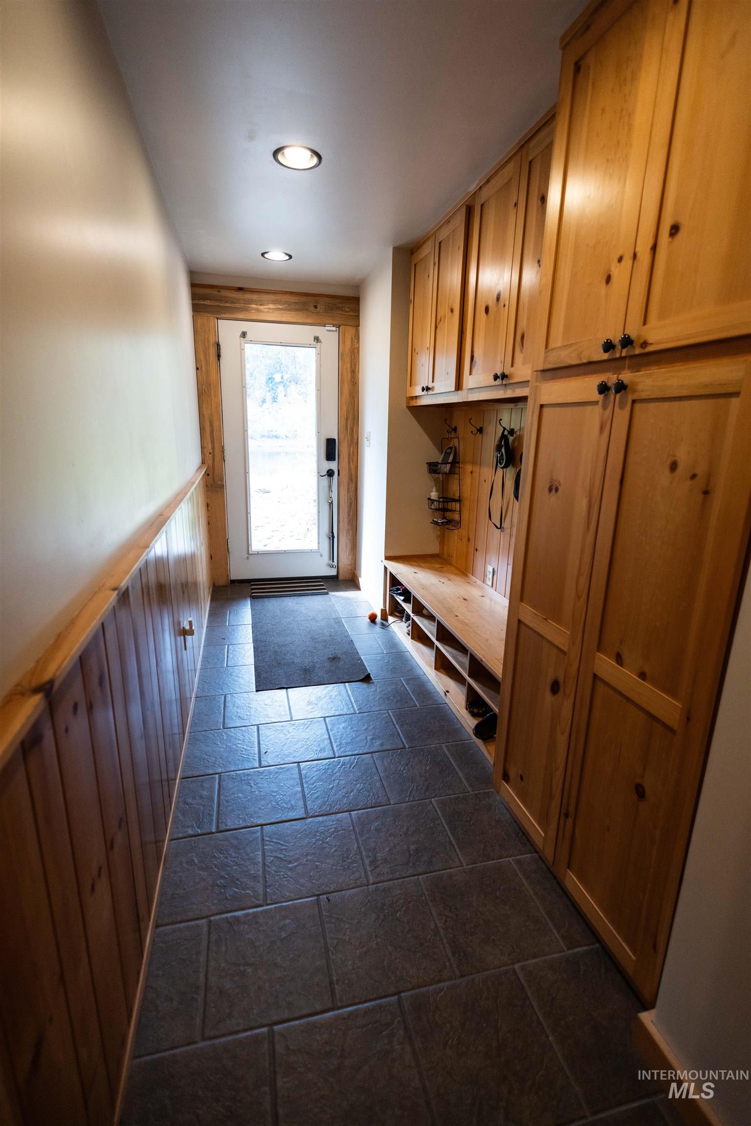 4480 Highway 12 Kamiah, ID 83536 - Photo 46 of 49 Mudroom featuring stone tile flooring, wood walls, a wainscoted wall, and recessed lighting