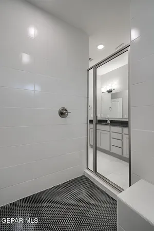 a bathroom with a shower and a mirror