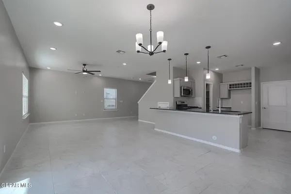 a view of a kitchen with a sink and a chandelier