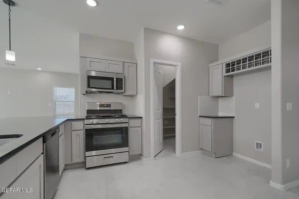 a kitchen with a stove and a refrigerator