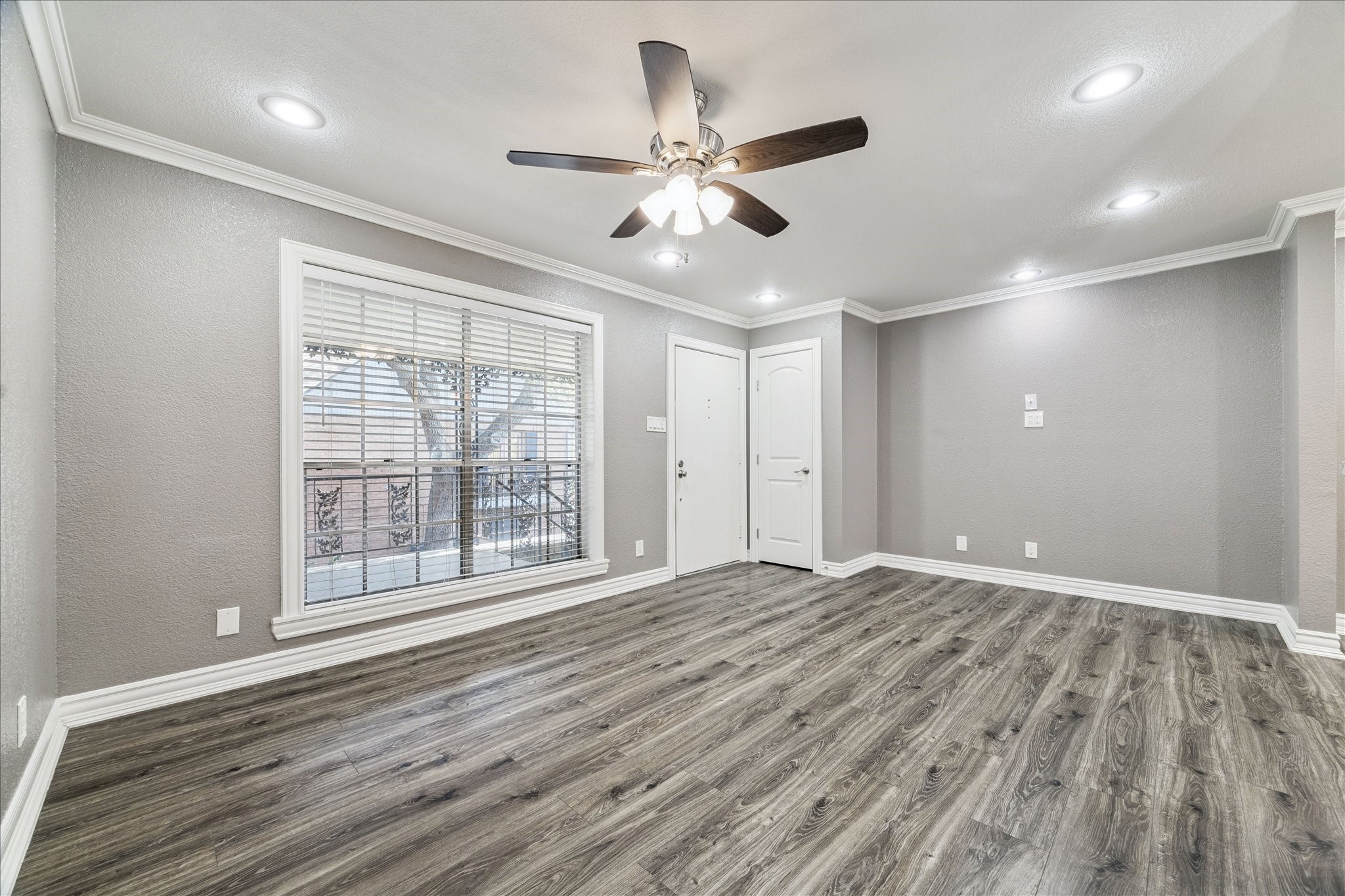 11550 Chimney Rock Road, Unit 321 Houston, TX 77035 - Photo 3 of 10 a view of an empty room with wooden floor and a window
