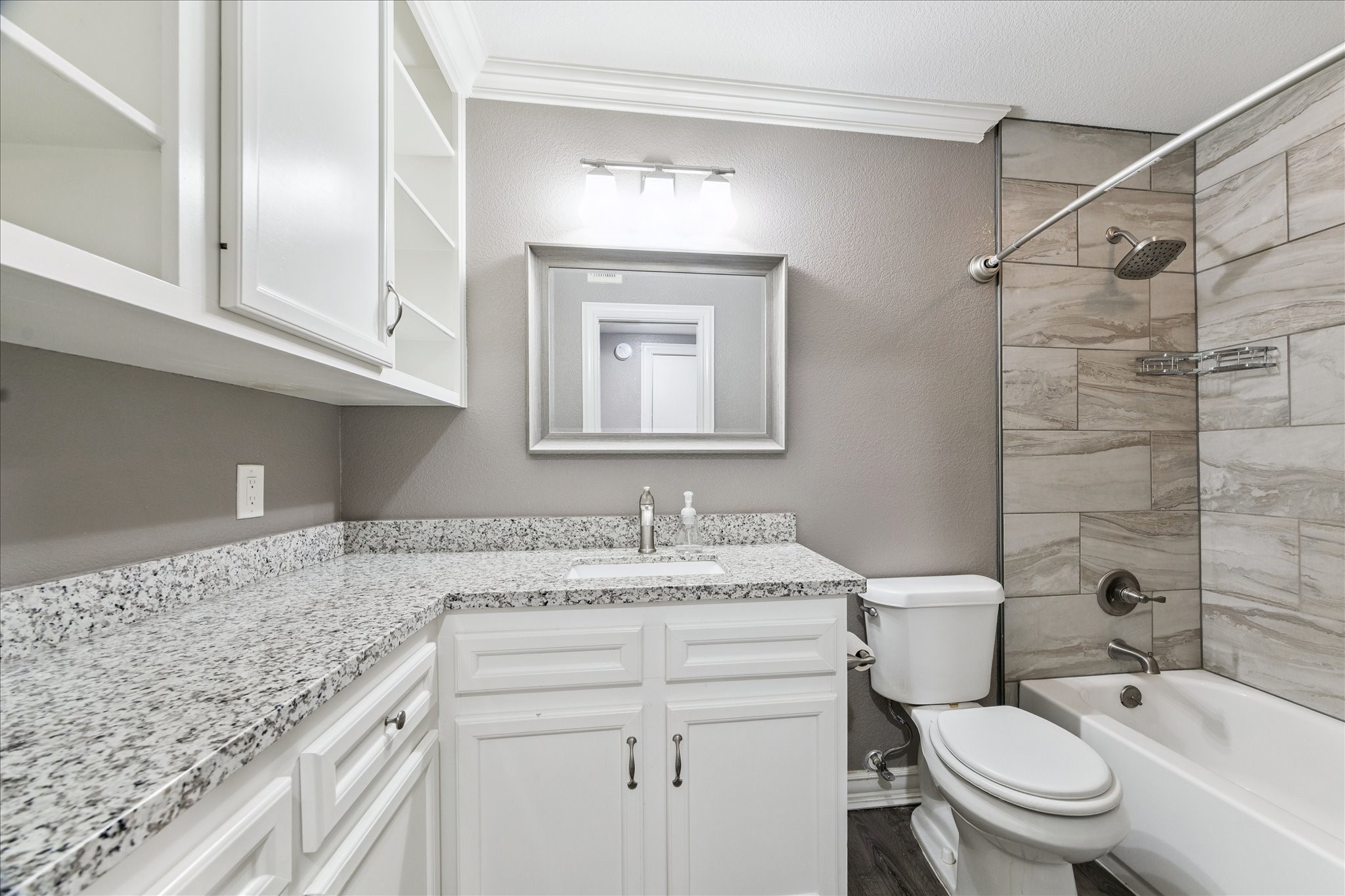 11550 Chimney Rock Road, Unit 321 Houston, TX 77035 - Photo 8 of 10 a bathroom with a granite countertop sink mirror vanity and toilet