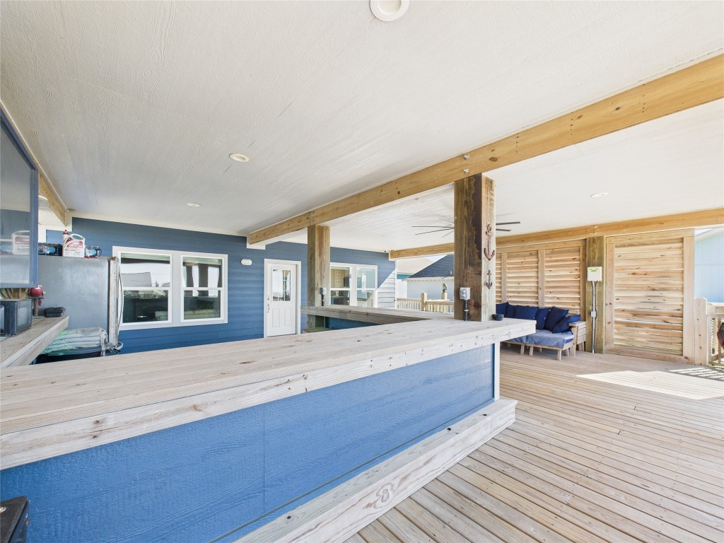 842 Main Street Crystal Beach, TX 77650 - Photo 20 of 45 a large white kitchen with granite countertop a large window and a counter top space