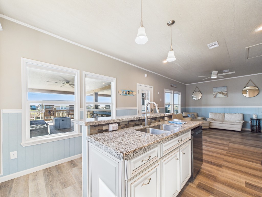 842 Main Street Crystal Beach, TX 77650 - Photo 26 of 45 a kitchen with granite countertop a sink and a stove