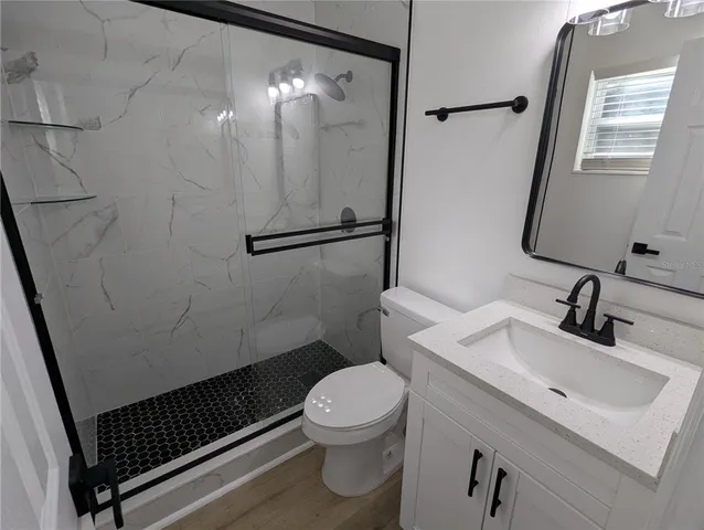 a bathroom with a sink toilet and shower