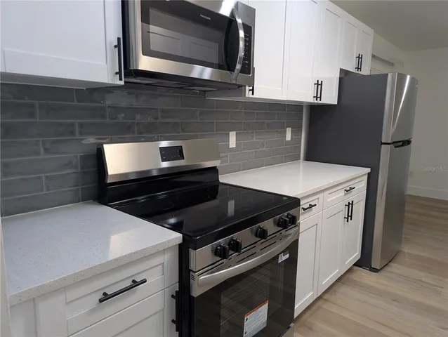 a kitchen with a stove microwave and refrigerator