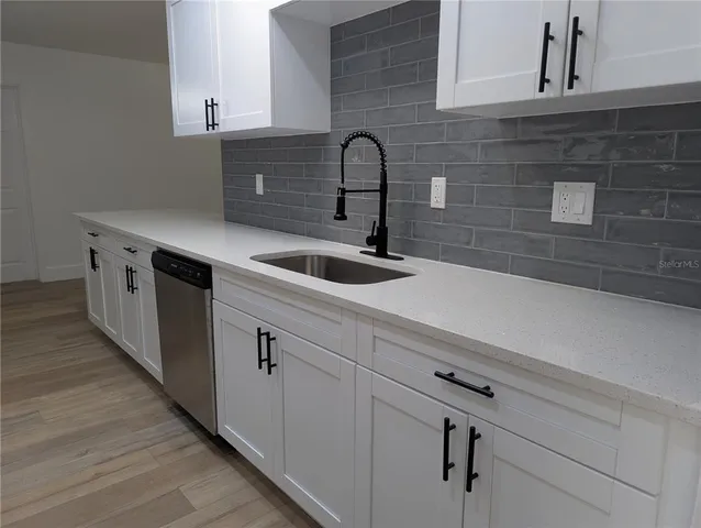 a kitchen with a sink and cabinets