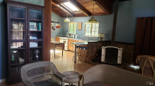 a living room with furniture a chandelier and floor to ceiling window