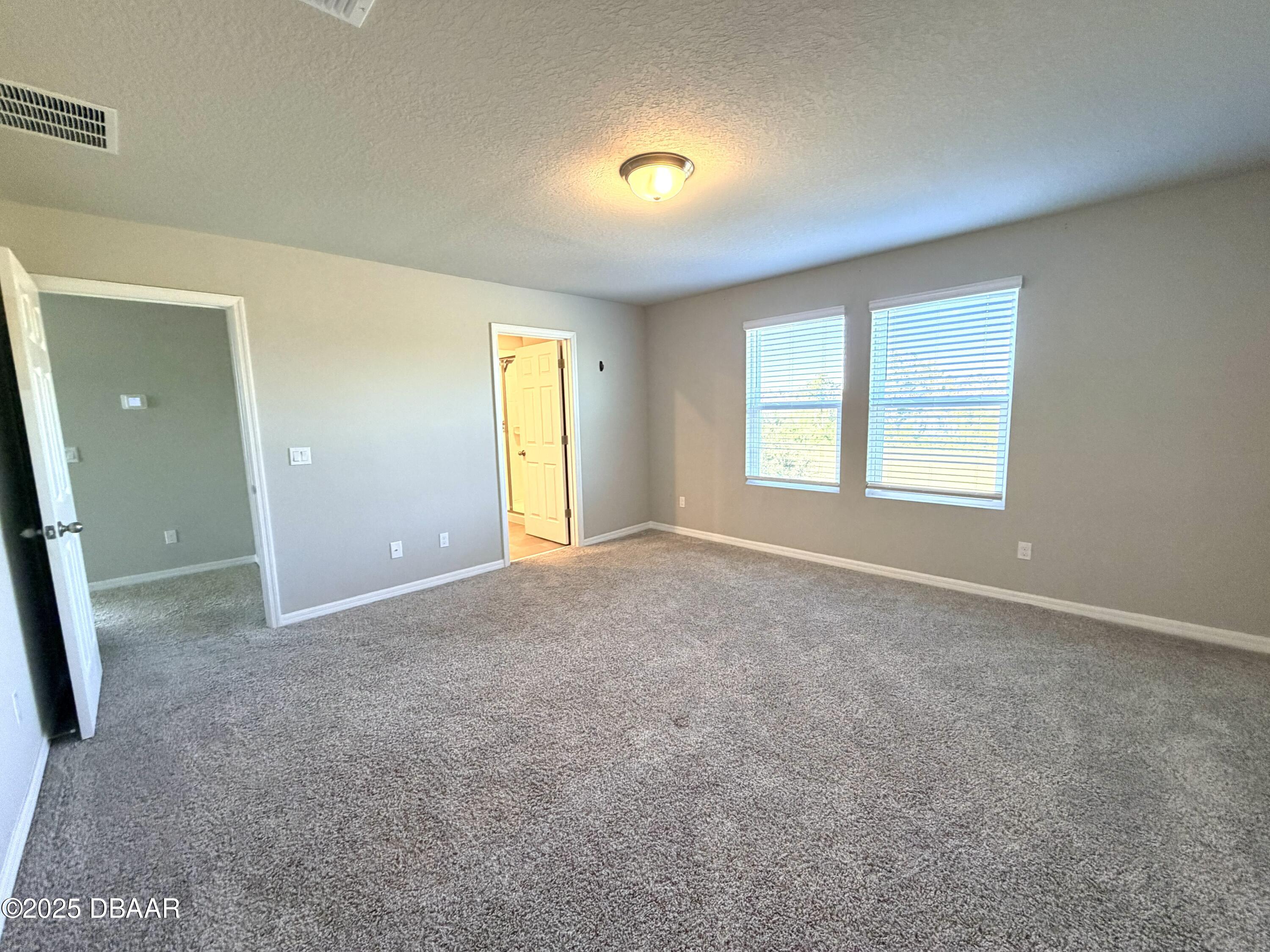 30224 Armenia Road Leesburg, FL 34748 - Photo 11 of 29 an empty room with windows and closet