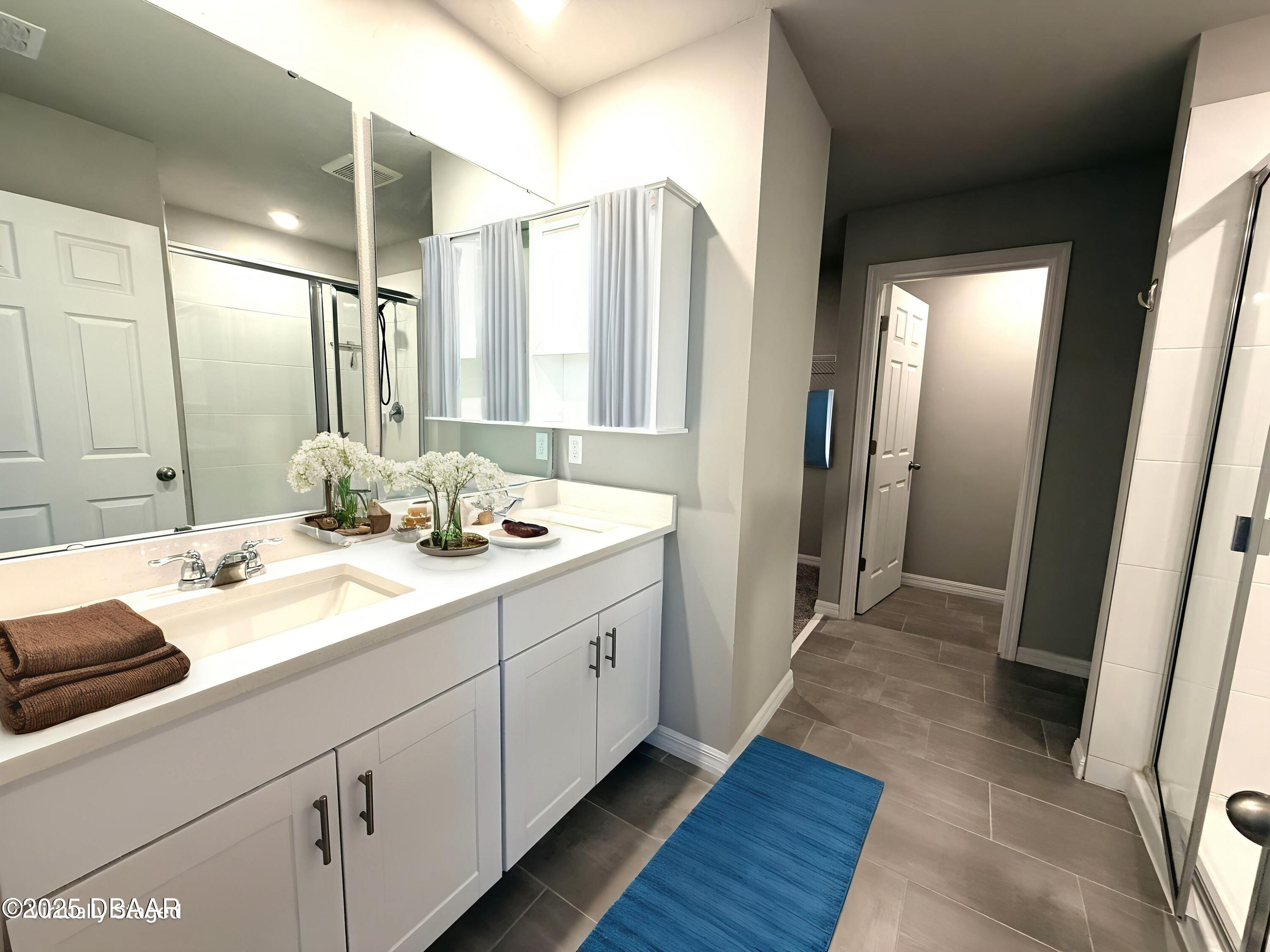30224 Armenia Road Leesburg, FL 34748 - Photo 13 of 29 a bathroom with a double vanity sink and a mirror