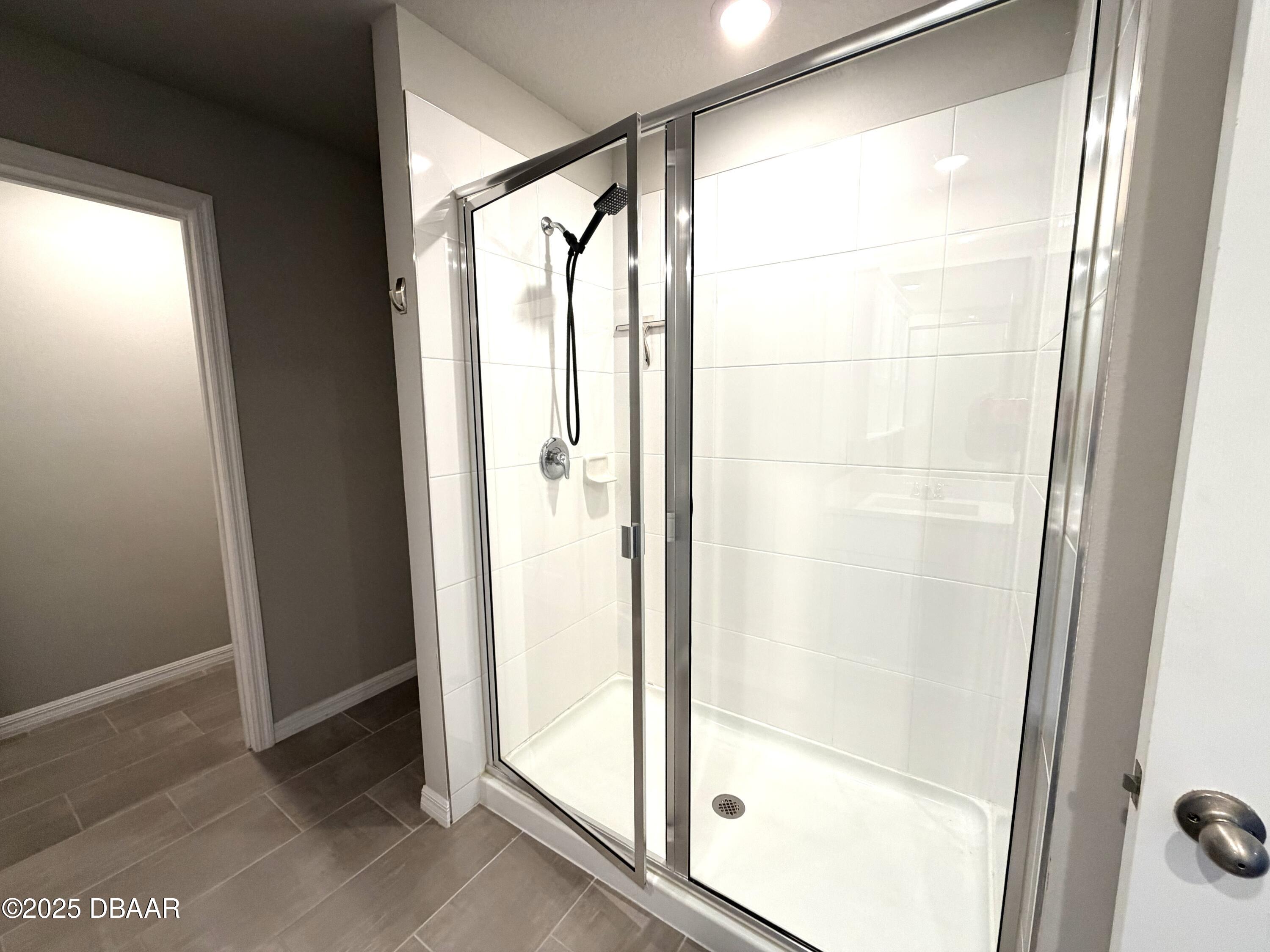 30224 Armenia Road Leesburg, FL 34748 - Photo 15 of 29 a bathroom with a glass shower door
