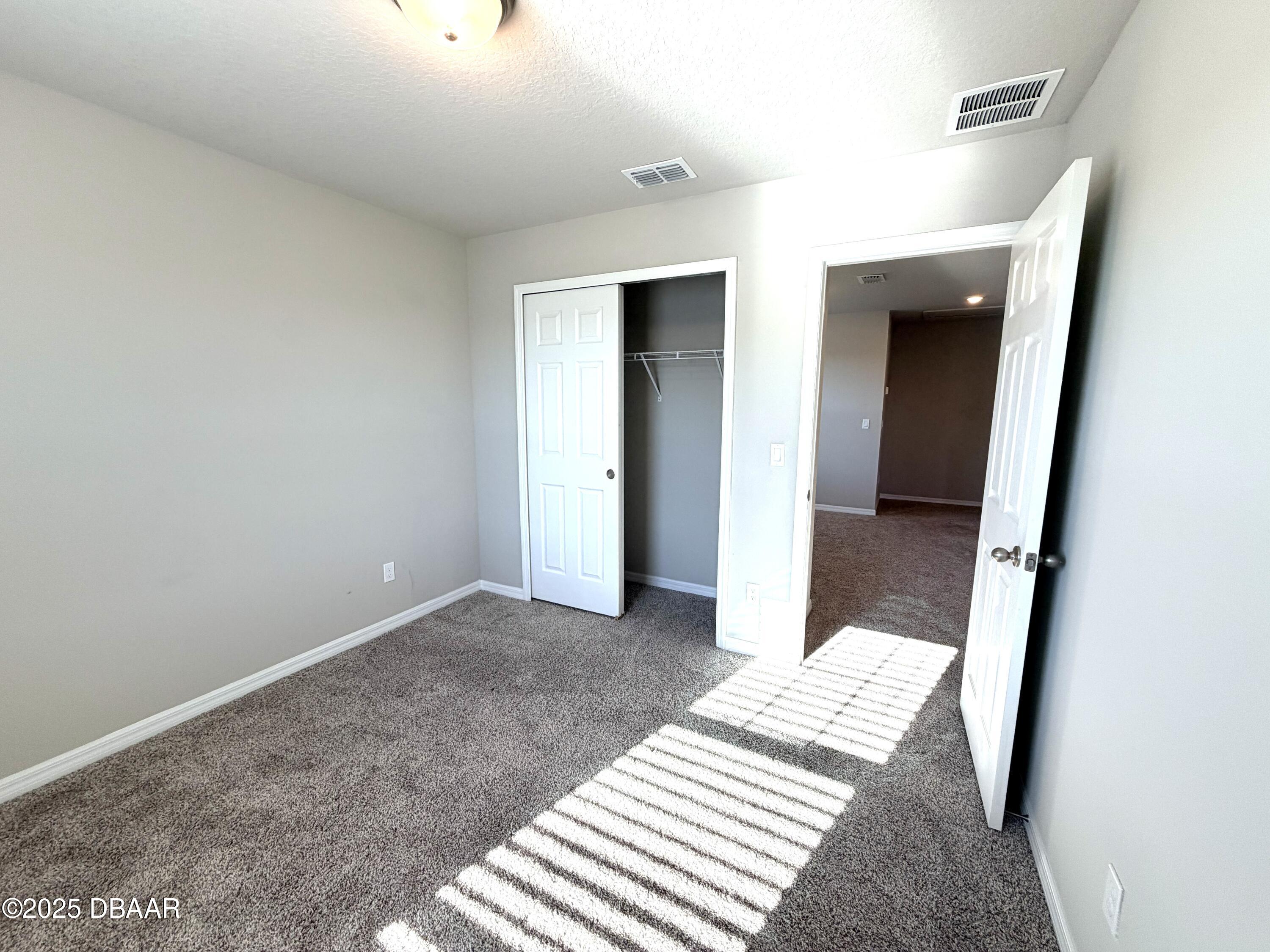 30224 Armenia Road Leesburg, FL 34748 - Photo 16 of 29 a view of a bedroom with wooden floor and bedroom
