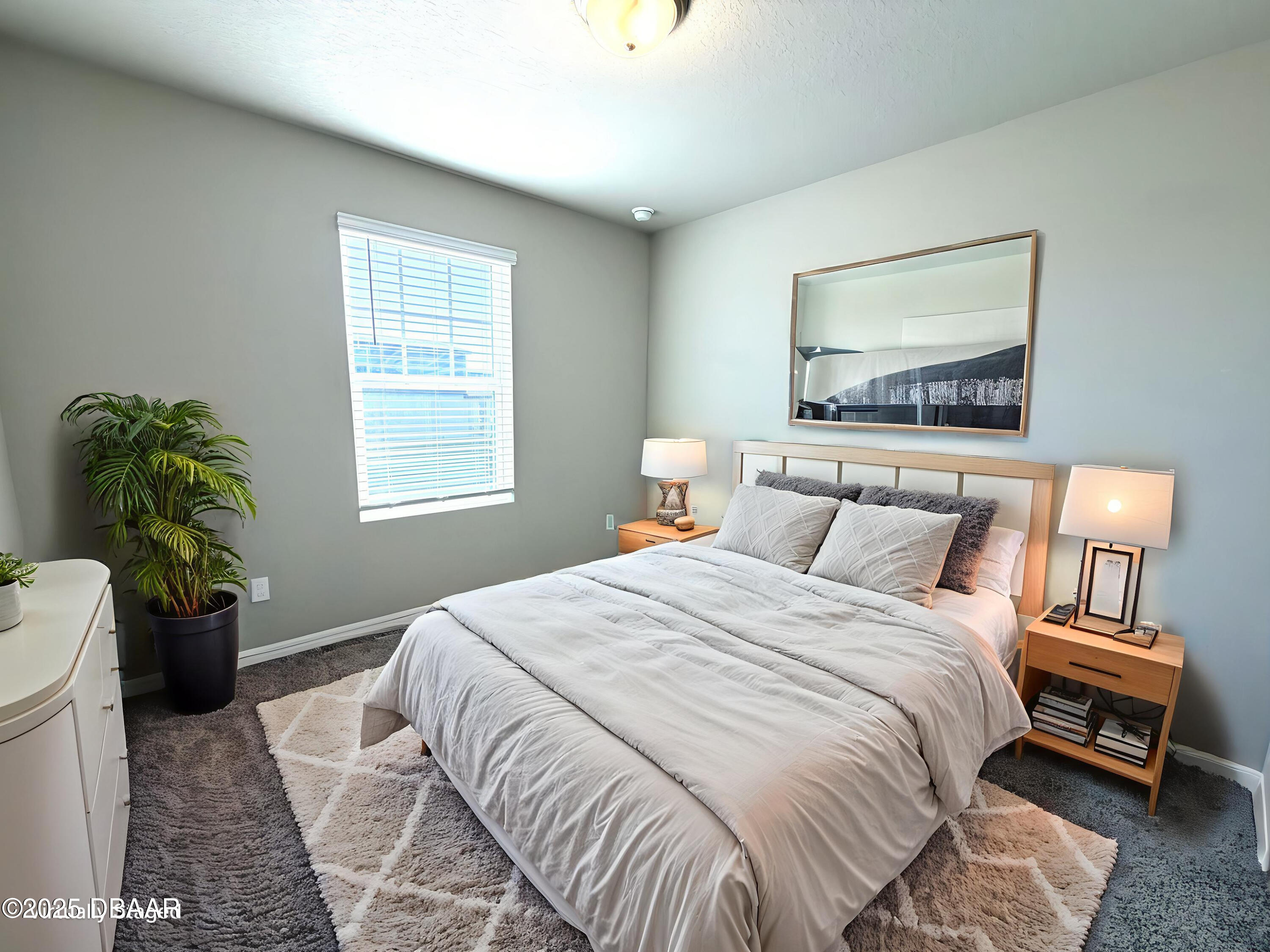 30224 Armenia Road Leesburg, FL 34748 - Photo 17 of 29 a bedroom with a bed and a painting on the wall