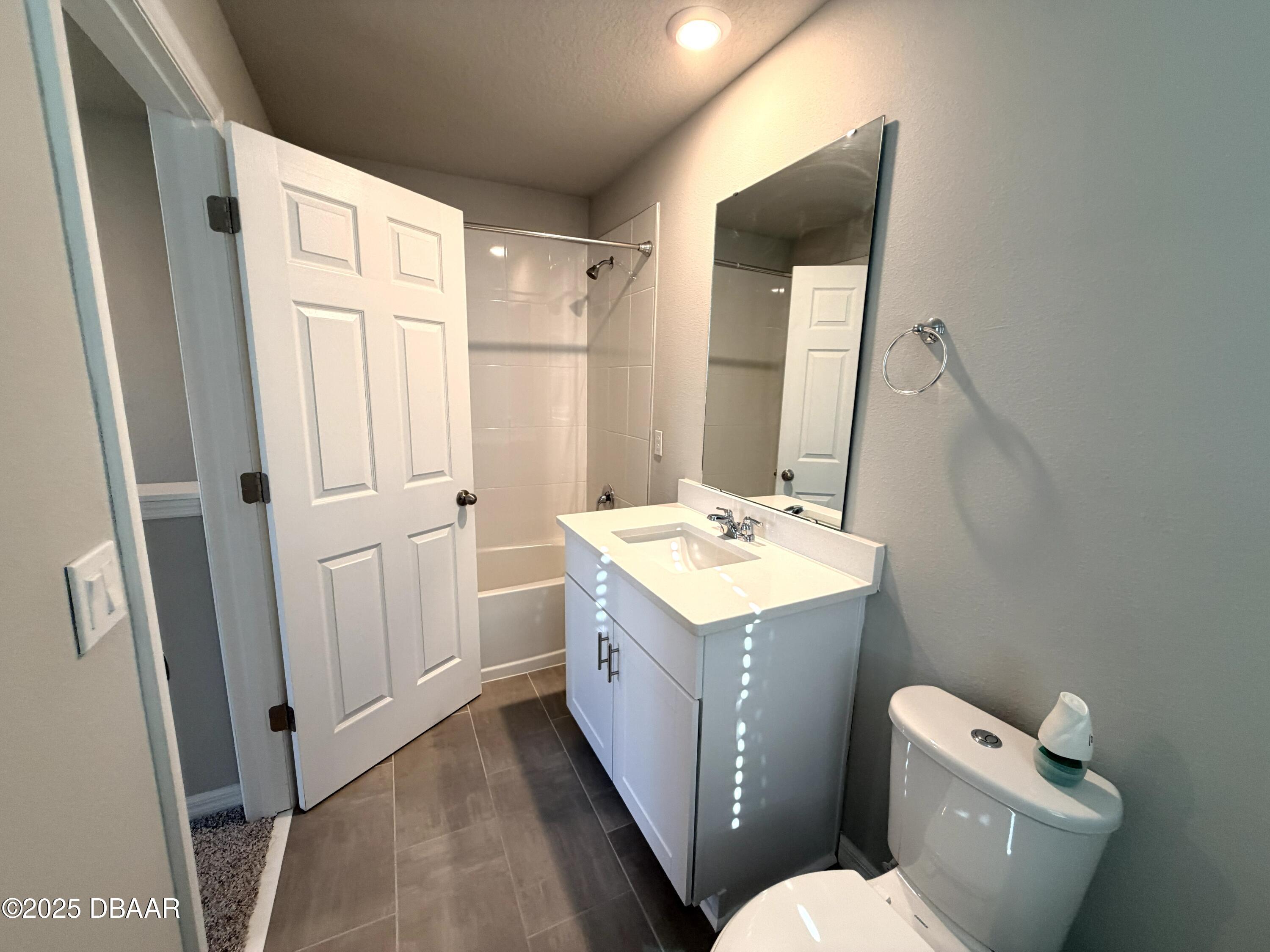 30224 Armenia Road Leesburg, FL 34748 - Photo 19 of 29 a bathroom with a sink a toilet and vanity
