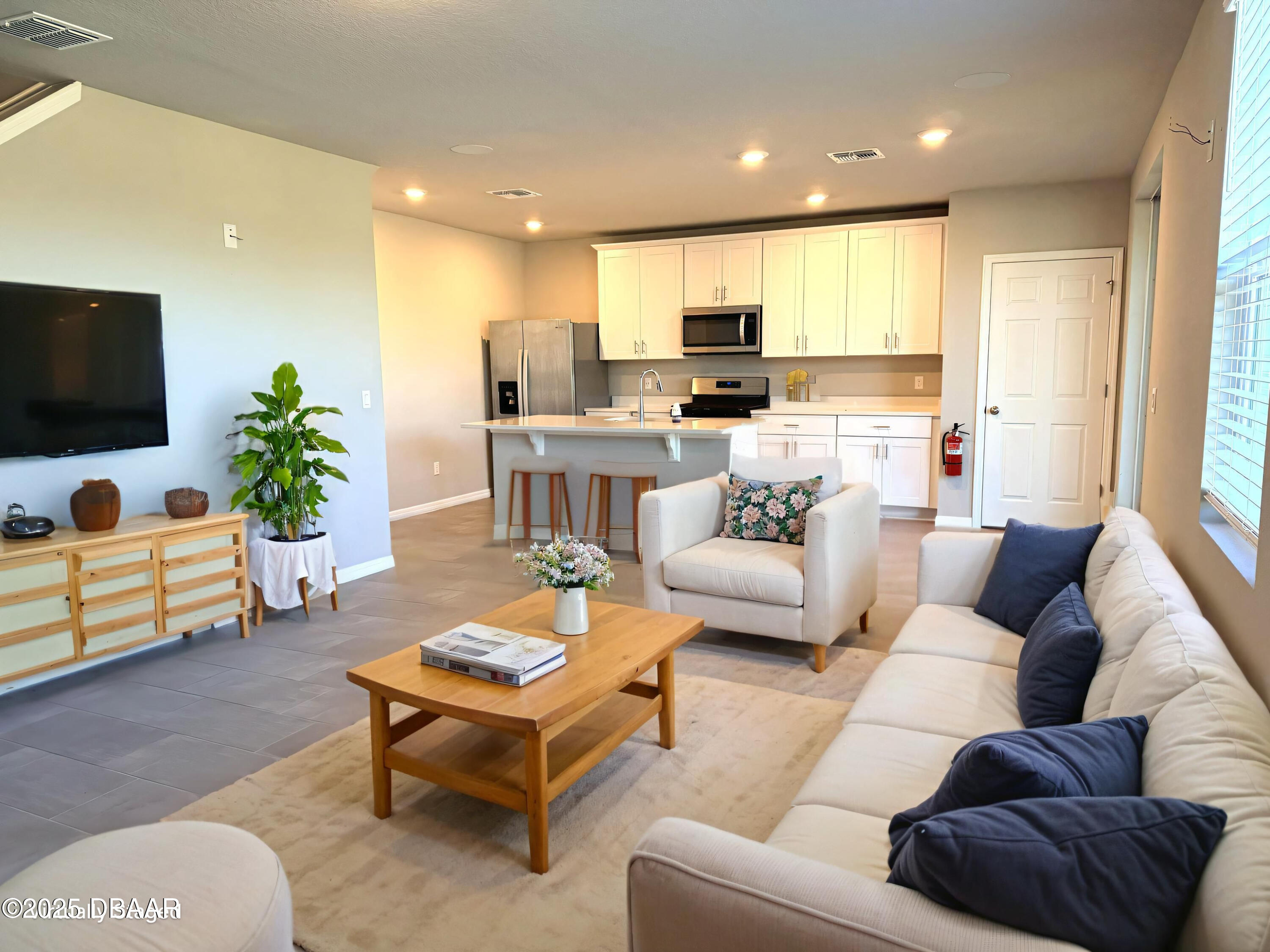 30224 Armenia Road Leesburg, FL 34748 - Photo 2 of 29 a living room with furniture and a flat screen tv