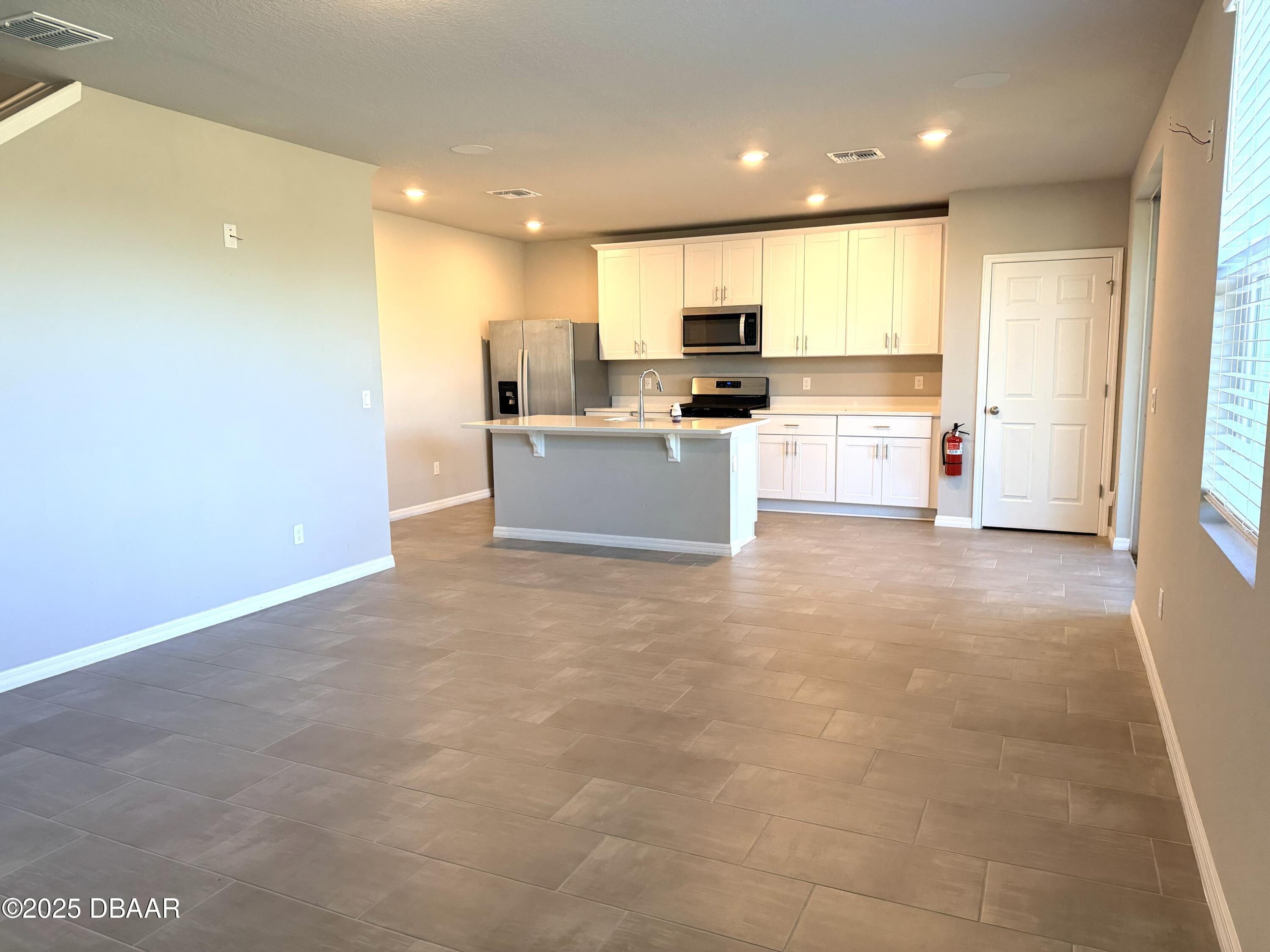 30224 Armenia Road Leesburg, FL 34748 - Photo 29 of 29 a large kitchen with a large counter top appliances and cabinets