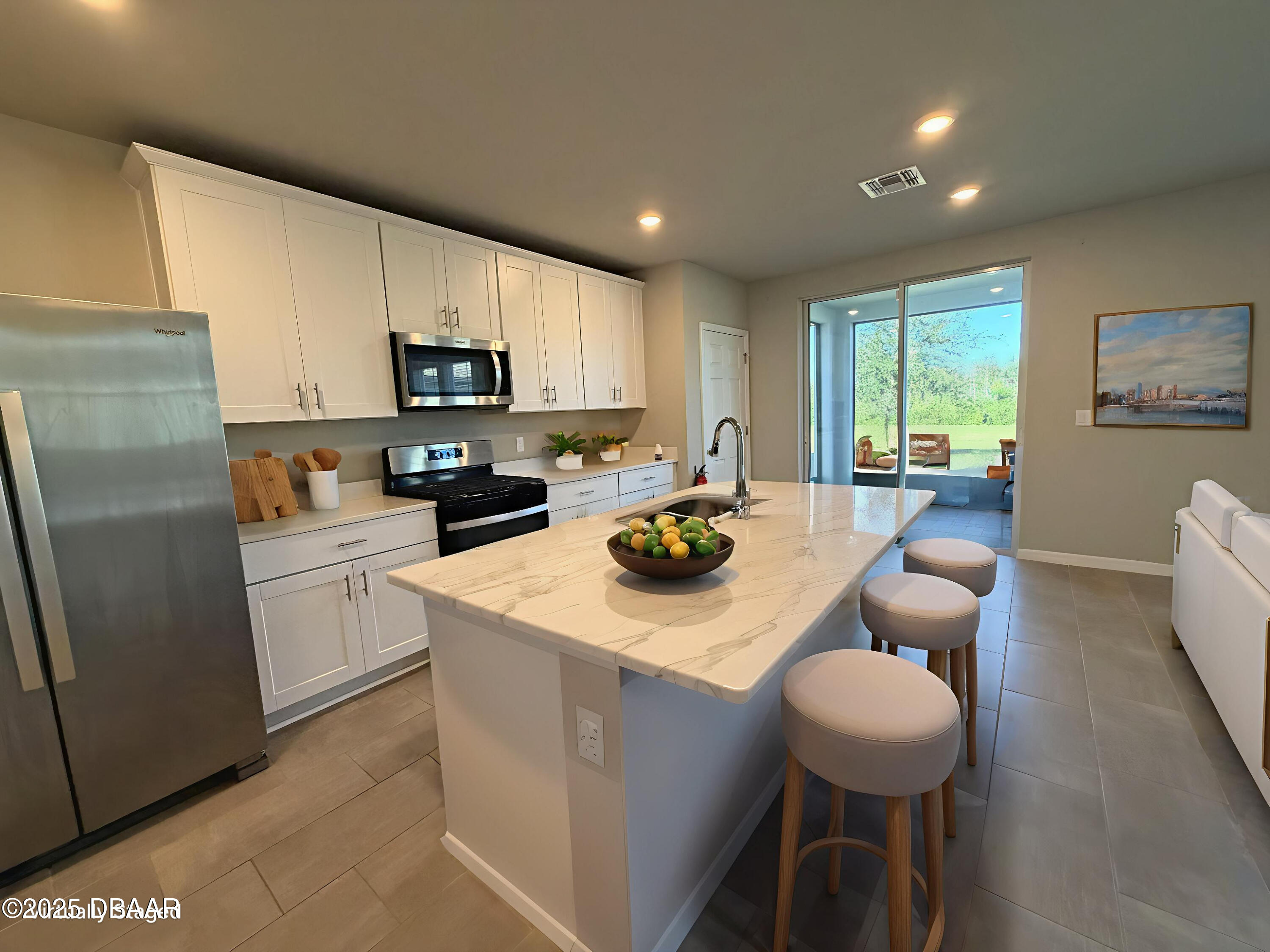 30224 Armenia Road Leesburg, FL 34748 - Photo 4 of 29 a kitchen with a sink a stove a refrigerator and a refrigerator