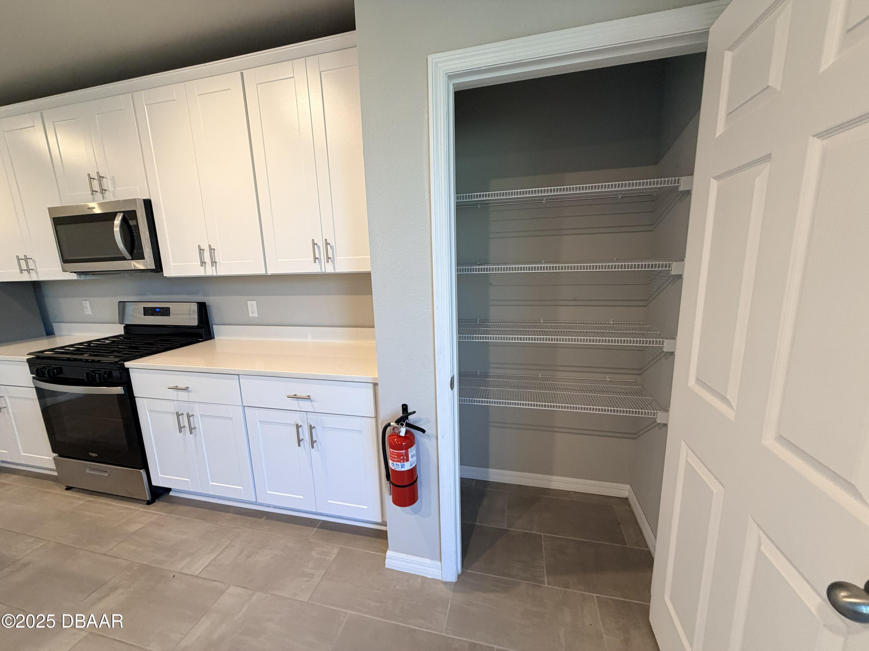 30224 Armenia Road Leesburg, FL 34748 - Photo 6 of 29 a kitchen with a sink a stove and cabinets