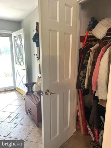 a living room with furniture a flat screen tv and a window