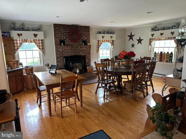 a living room with furniture a fireplace and a window
