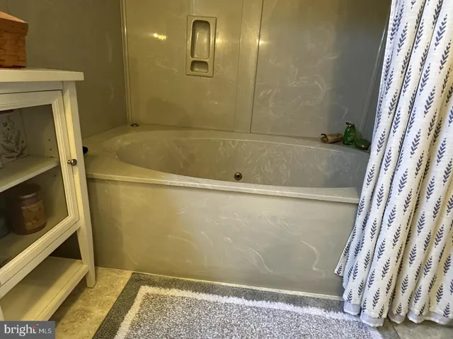 a bathroom with a granite countertop toilet sink and mirror