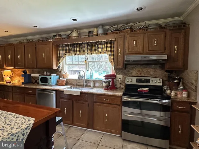 a kitchen with a sink appliances and cabinets