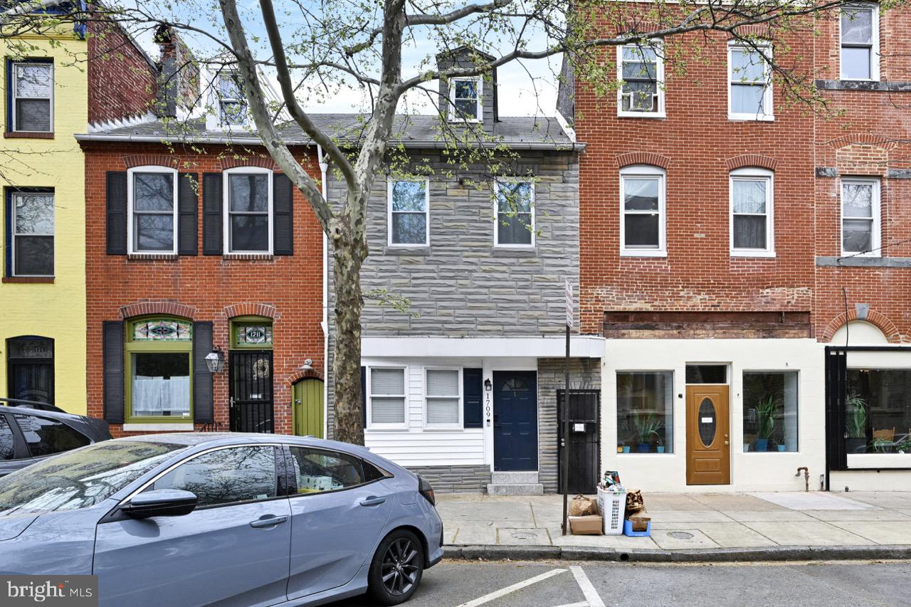 1709 Bank Street Baltimore, MD 21231 - Photo 49 of 49 a front view of a house with car parked