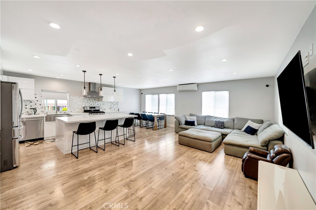 a living room with lots of furniture and kitchen view