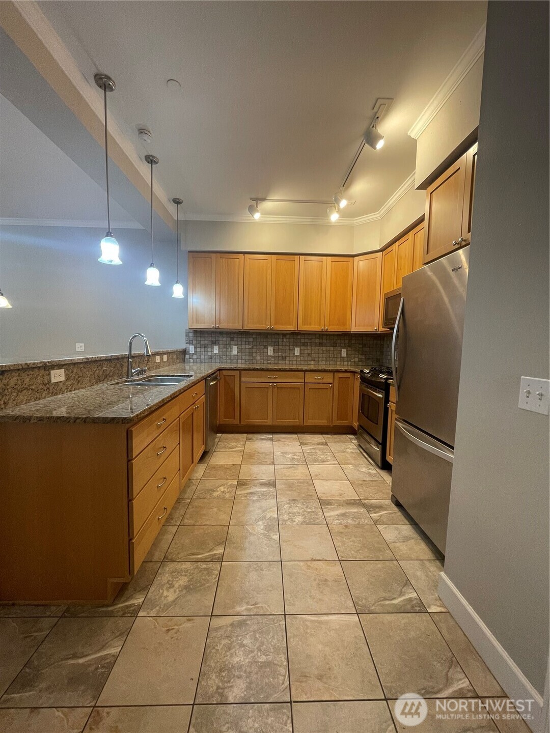 1101 McKenzie Avenue, Unit 206 Bellingham, WA 98225 - Photo 6 of 16 a large kitchen with a large counter top and stainless steel appliances