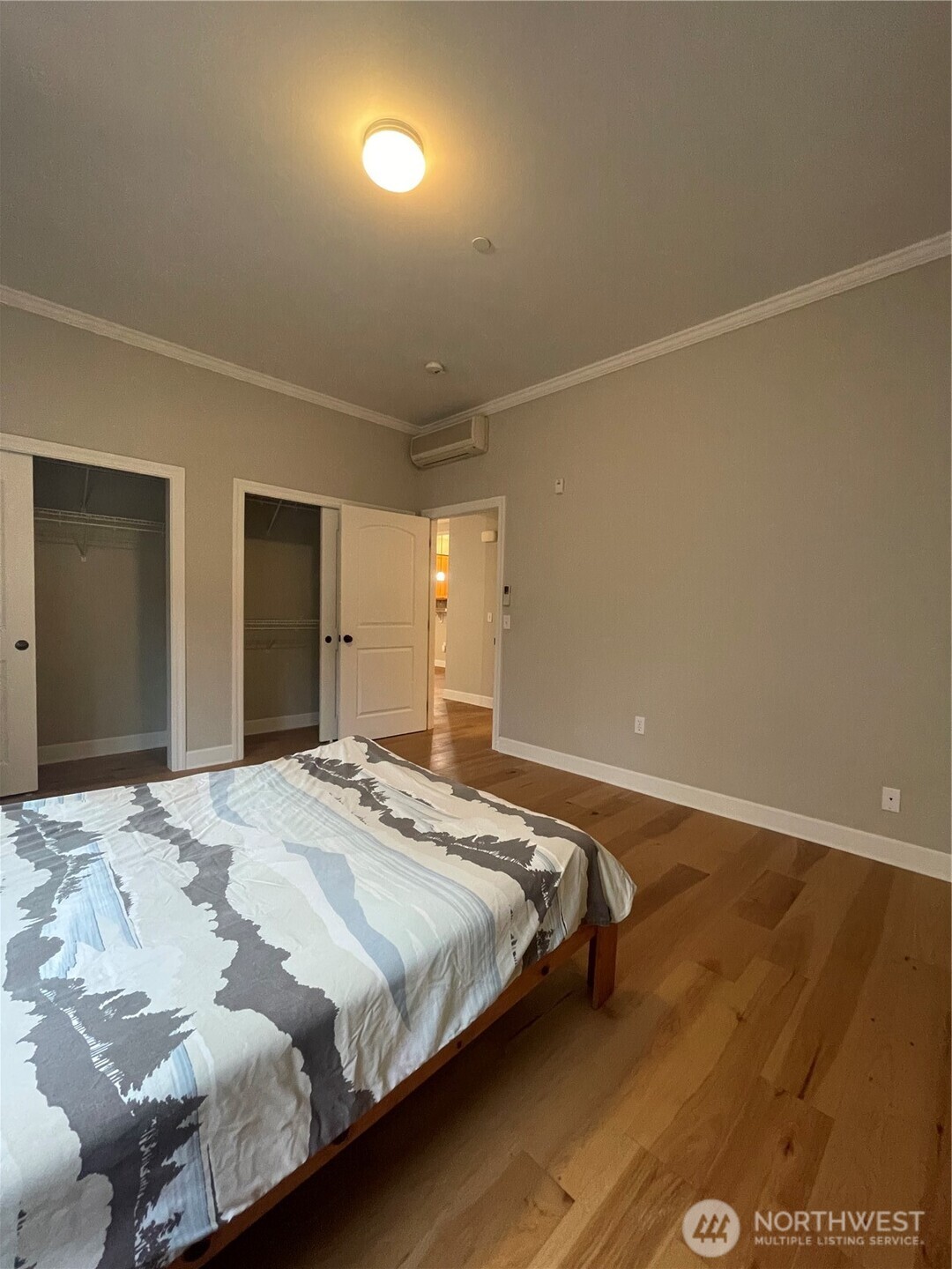 1101 McKenzie Avenue, Unit 206 Bellingham, WA 98225 - Photo 8 of 16 a bedroom with a bed and a mirror