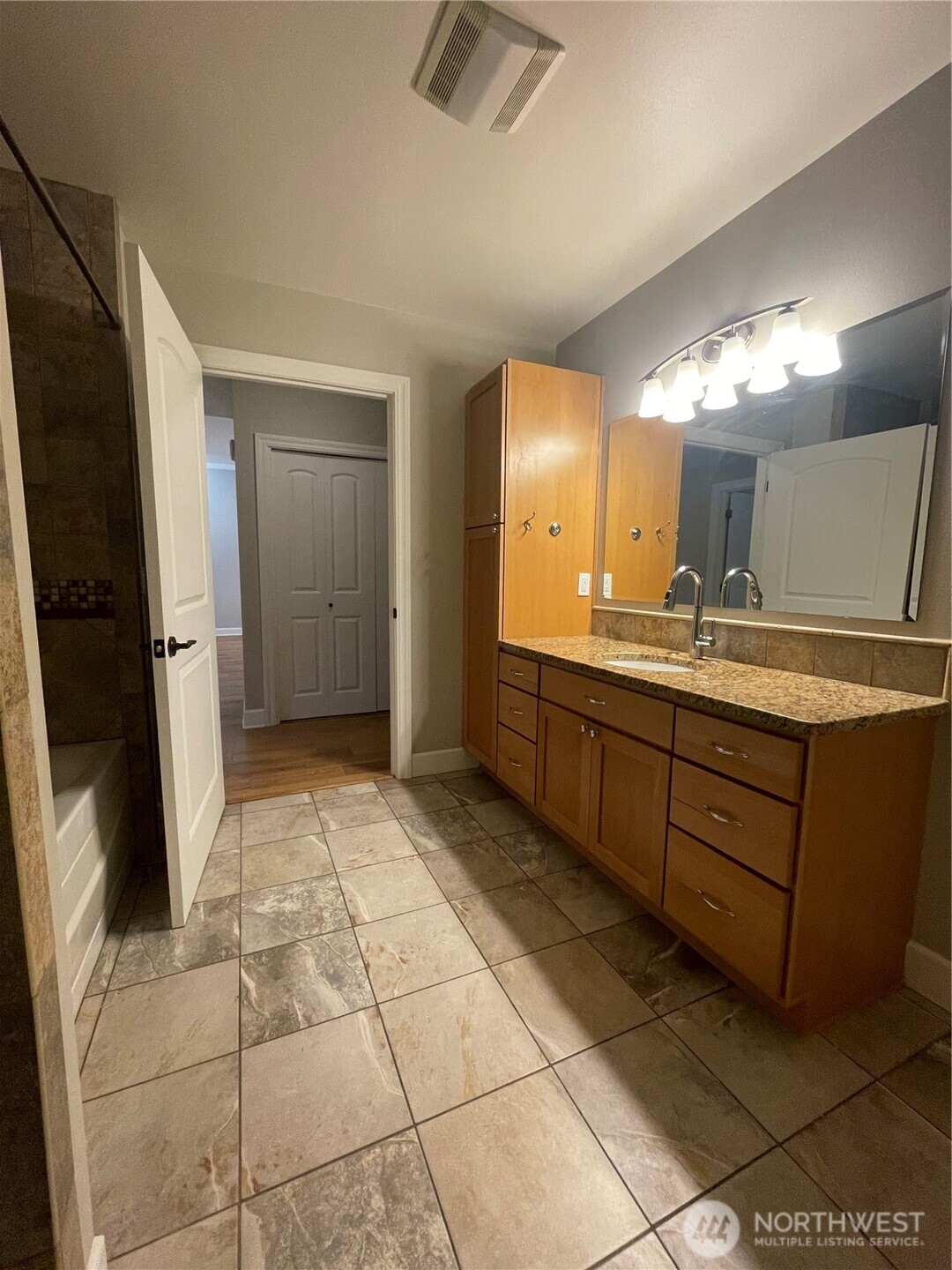 1101 McKenzie Avenue, Unit 206 Bellingham, WA 98225 - Photo 10 of 16 a bathroom with a sink a mirror and a shower