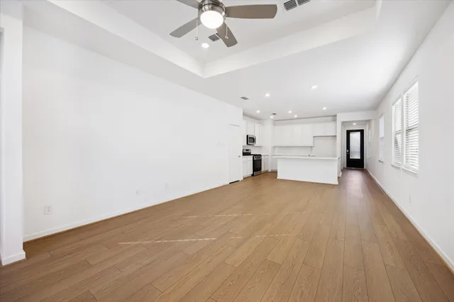 a view of empty room with wooden floor