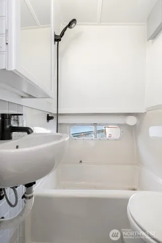 a bathroom with a sink a toilet and bathtub