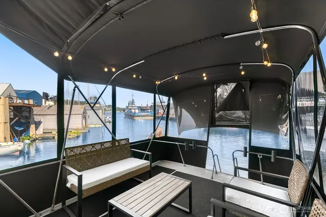 a view of a balcony with chairs and wooden floor