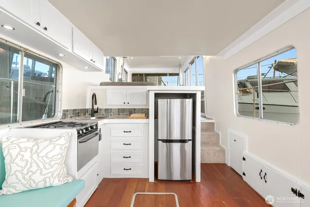 a kitchen with stainless steel appliances granite countertop a refrigerator and a stove top oven