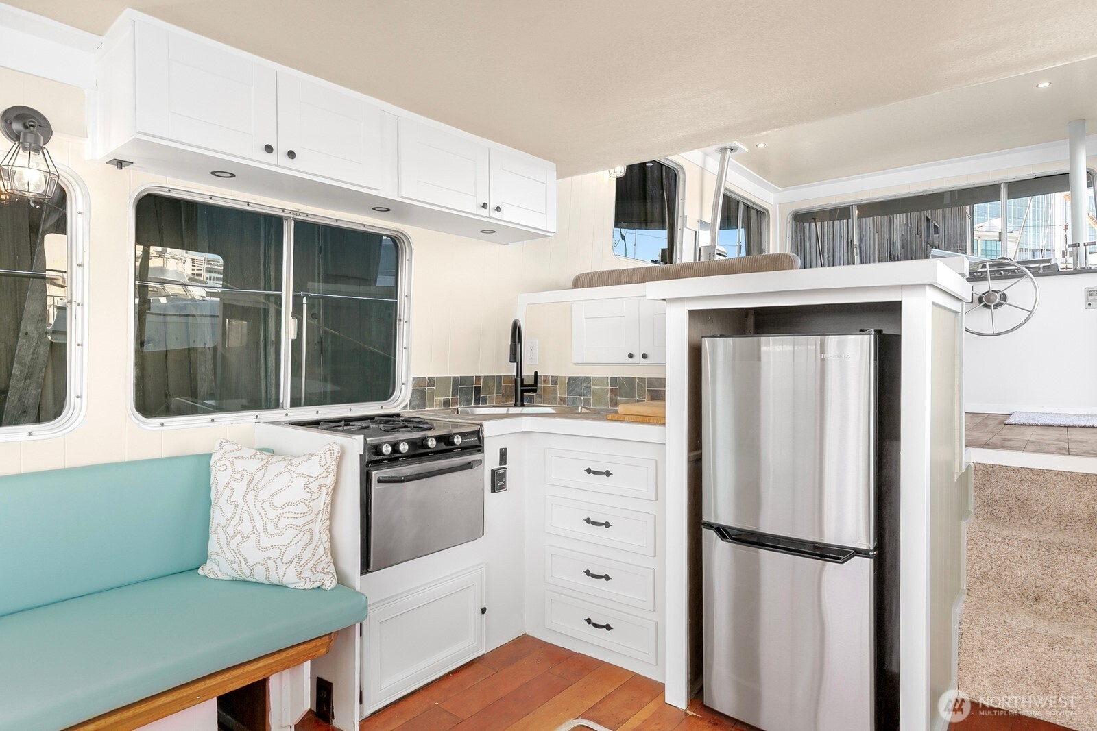 1325 Fairview Avenue North Seattle, WA 98109 - Photo 4 of 23 a kitchen with stainless steel appliances granite countertop a refrigerator a stove and a sink