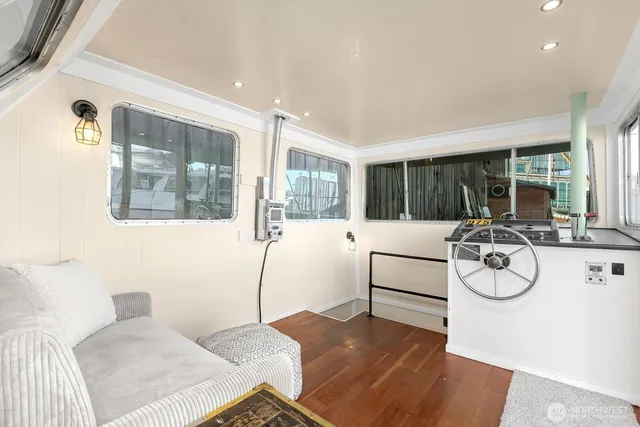 a living room with furniture a table and white walls