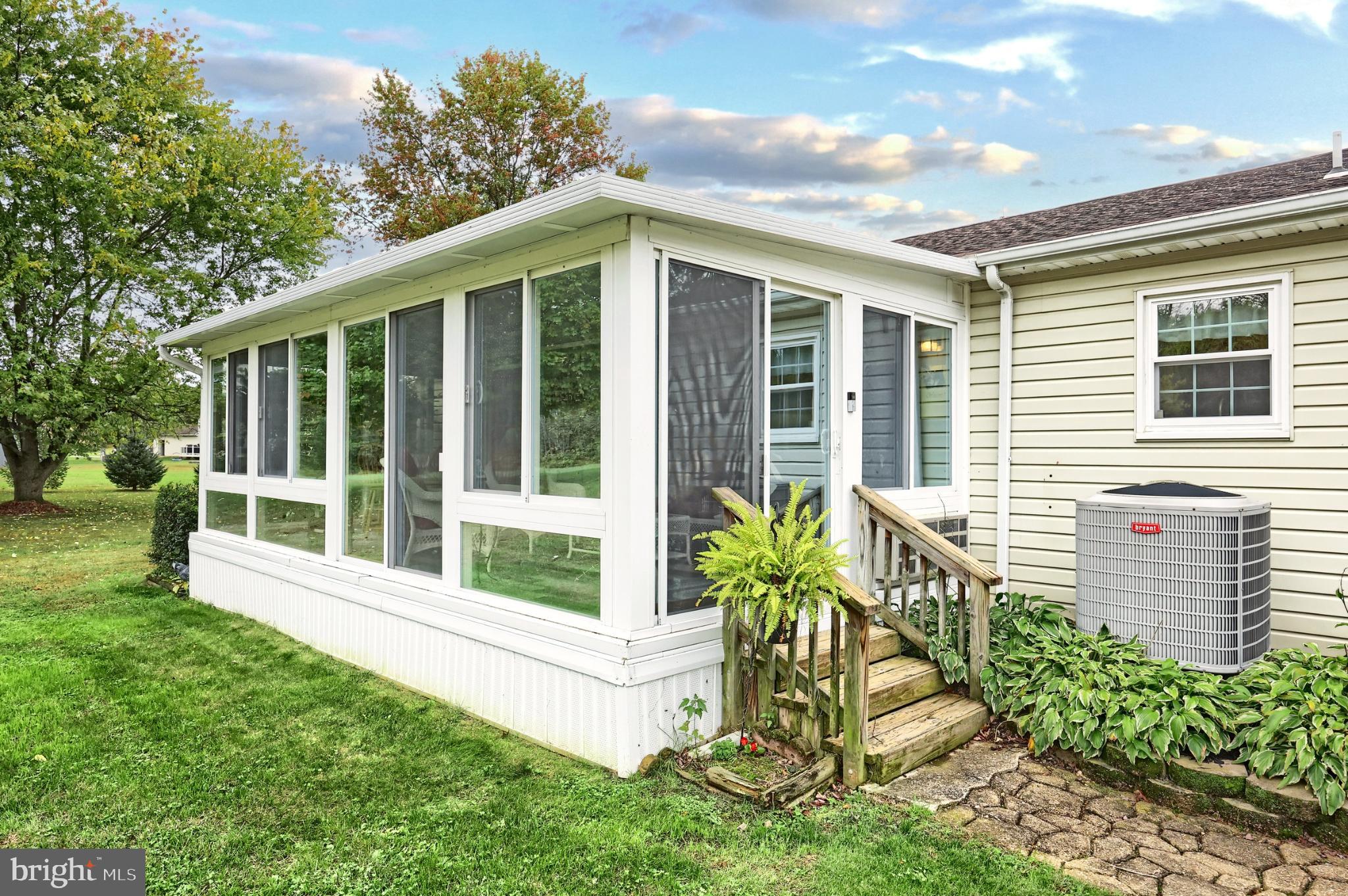 5040 Rocky Road Glenville, PA 17329 - Photo 37 of 49 Charming sunroom with lush greenery backdrop.