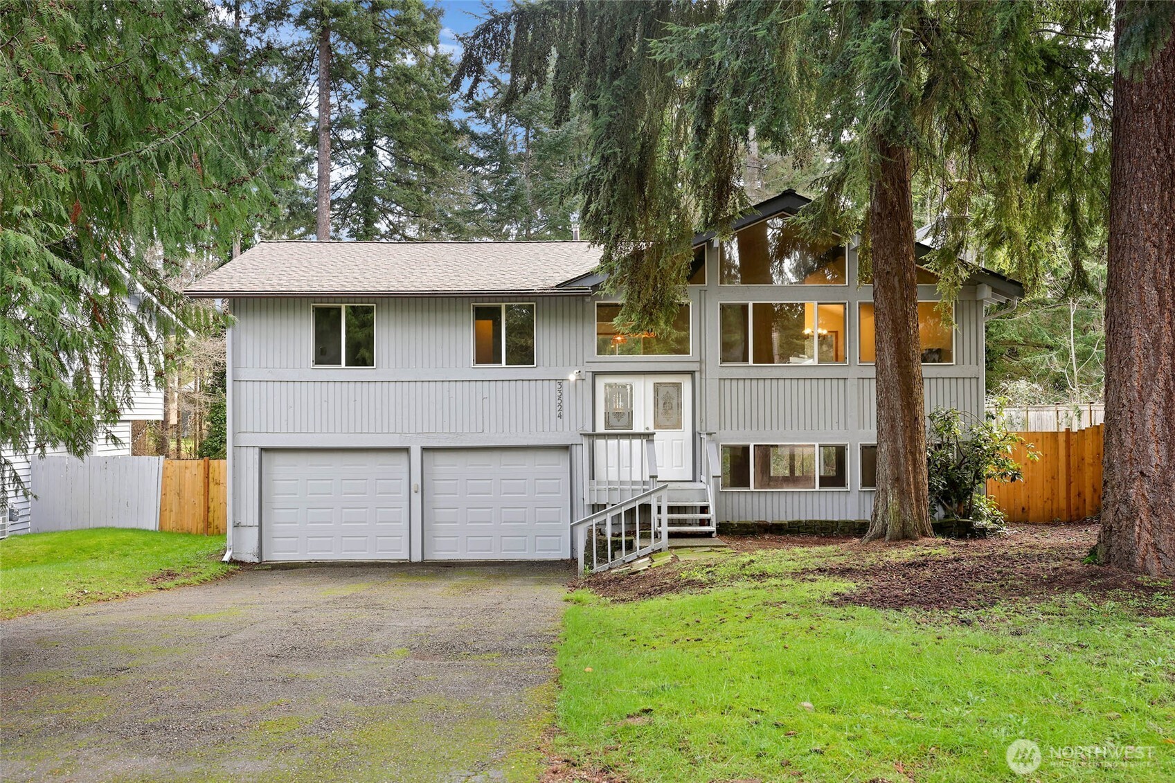 33524 33rd Place Southwest Federal Way, WA 98023 - Photo 1 of 37 a front view of a house with a yard