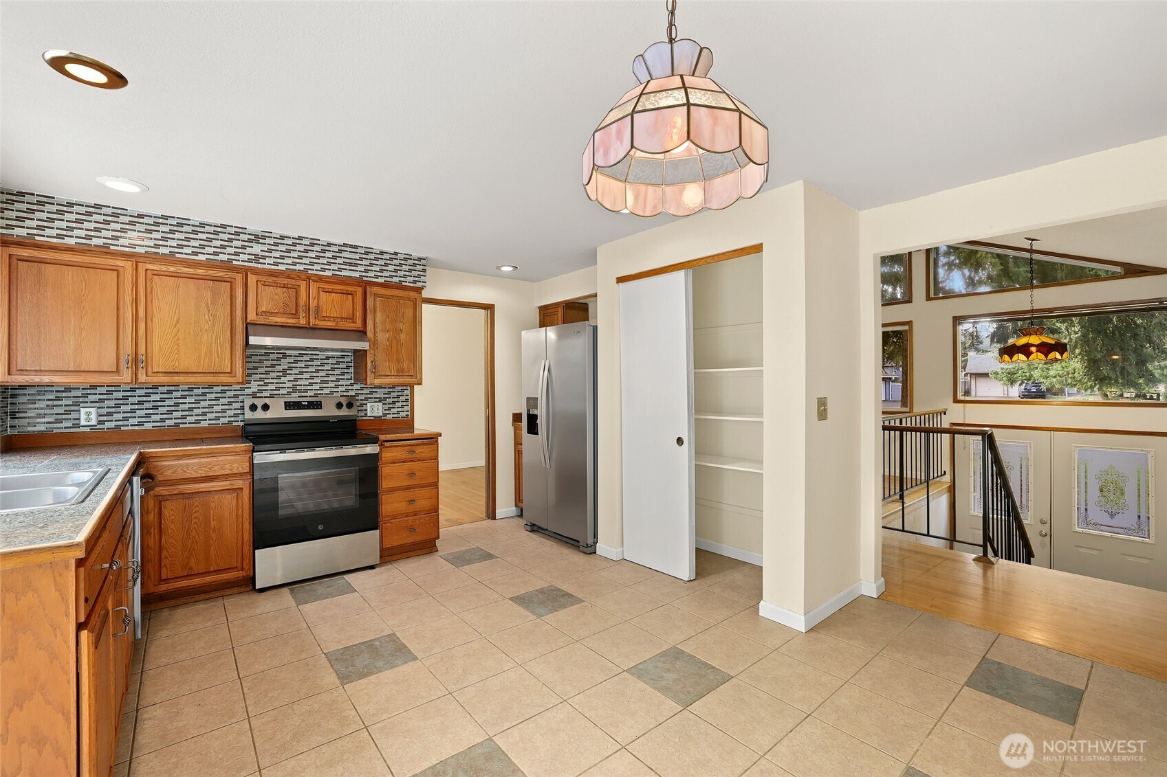 33524 33rd Place Southwest Federal Way, WA 98023 - Photo 8 of 37 a kitchen with stainless steel appliances granite countertop a refrigerator and a stove top oven
