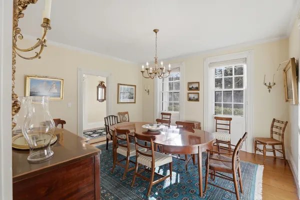 a living room with furniture and painting on the wall