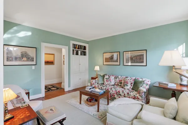 a living room with furniture fireplace and a large window
